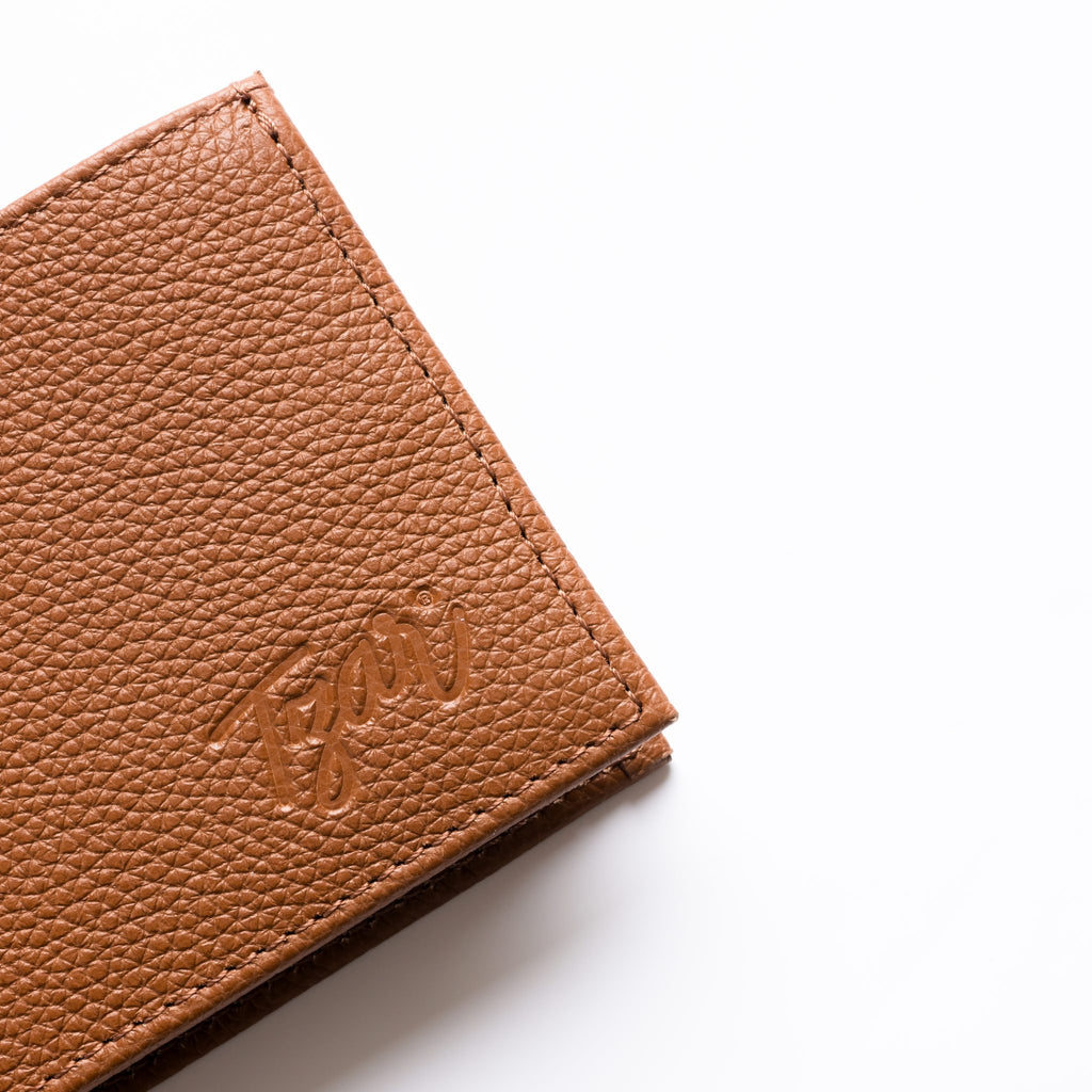 Close-up of a brown leather wallet with 'Zion' branding on a white background